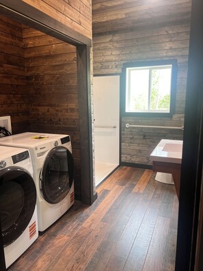 A laundry room with two washers and a dryer, a window, and a sink. - Lost Lake Moonlight Cabin- New build, Lake Front 2BD 2Bath - ADA - hot tub (Bagley)