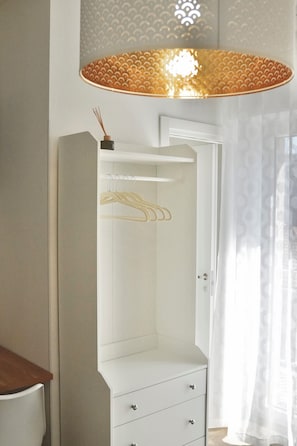 A room with a wardrobe, a hanging rack, and a pendant light. - Termoli Station (Termoli)