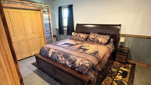 A bedroom with a large bed, wooden wardrobe, and a window with curtains. - Perfect 2-bedroom apartment in wonderful Wyarno for your stay (Wyarno)
