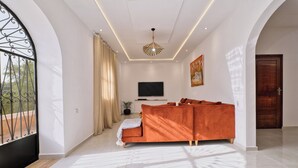 A modern living room with a sofa, TV, and decorative lighting. - Villa Aisha . Private Pool & Garden Retreat – 20 min from Essaouira (Essaouira)