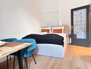 Ein Schlafzimmer mit einem Bett, einem Tisch und einem Stuhl.