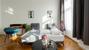 Una camera d'albergo moderna con un letto, una scrivania, una sedia e una finestra con tende.