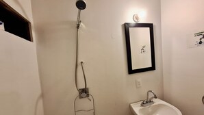 A bathroom with a shower, sink, and mirror. - Casa G 36 M8  (Mexico City)