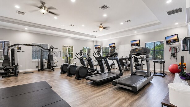 A gym with treadmills, elliptical machines, and weight equipment. - Live the Naples Lifestyle.. Resort Amenities & Coastal Charm (Naples)