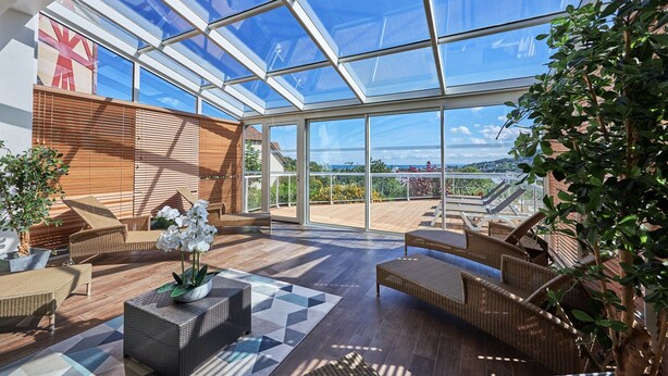 A spacious indoor area with a high ceiling, large windows, and outdoor views. - Aesthetic Normandy House for 6 With Pool (Houlgate)