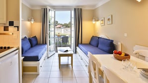 A compact room with a kitchenette, a dining area, and a seating area with a view. - Bourgenay Flat Near Coastal Slopes (Talmont-Saint-Hilaire)