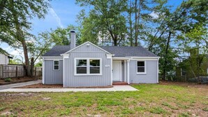 A single-story house with a small garage, a front door, and a visible mailbox. - 3BR Augusta Retreat Near Medical, VA & Downtown (Augusta)