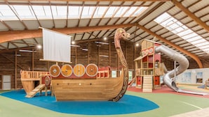 A wooden ship play structure with slides and climbing elements. - Family Apartment for 4 in Normandy (Branville)