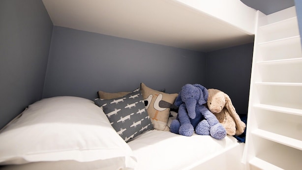 A bunk bed with a white mattress, a pillow with a pattern, and a stuffed toy. - Chewton Glen Hotel and Spa (New Milton)