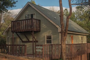A two-story building with a balcony, a sign reading 'Mountain Haven,' and a wooden fence.