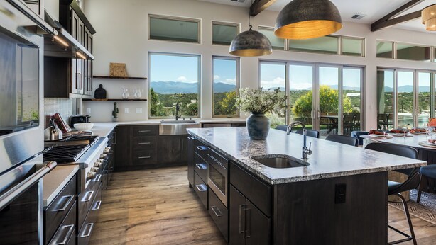 A modern kitchen with a large island, stainless steel appliances, and a view of the outdoors. - Santa Fe Design Home · Stargazing Dome, Sauna, Cold Plunge & Mountain Views (Santa Fe)
