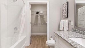 A bathroom with a shower, toilet, and sink. - Landing | Incredible 1BD, Gym, Clubhouse (Orlando)