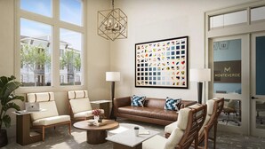 A modern living room with a brown leather sofa, beige armchairs, a coffee table, and a large abstract painting. - Landing | Amazing 1BD in Northwest Side (San Antonio)