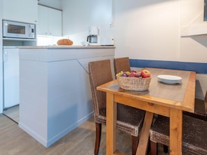 A compact kitchenette with a microwave, coffee maker, and a small table with chairs. - Retreat Near the Baie de Somme (Fort-Mahon-Plage)