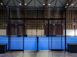 A sports facility with a blue floor, metal fencing, and a wooden ceiling structure. - Retreat Near the Baie de Somme (Fort-Mahon-Plage)