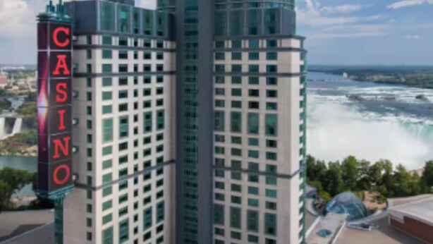 A tall hotel with a prominent casino sign, featuring a modern glass facade and a dome-like structure on top. - Spacious Getaway Stay w/ 4BR & 3BA| Niagara Falls (Welland)