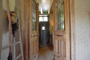 A narrow hallway with wooden doors and a ladder on the left. - Alphen Retreat With Sauna (Alphen)