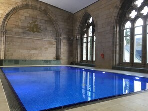 A large indoor swimming pool with stone walls and arched windows. - Ancluaran (The Thistle) newly renovated one bedroom house 2+2 (Fort Augustus)
