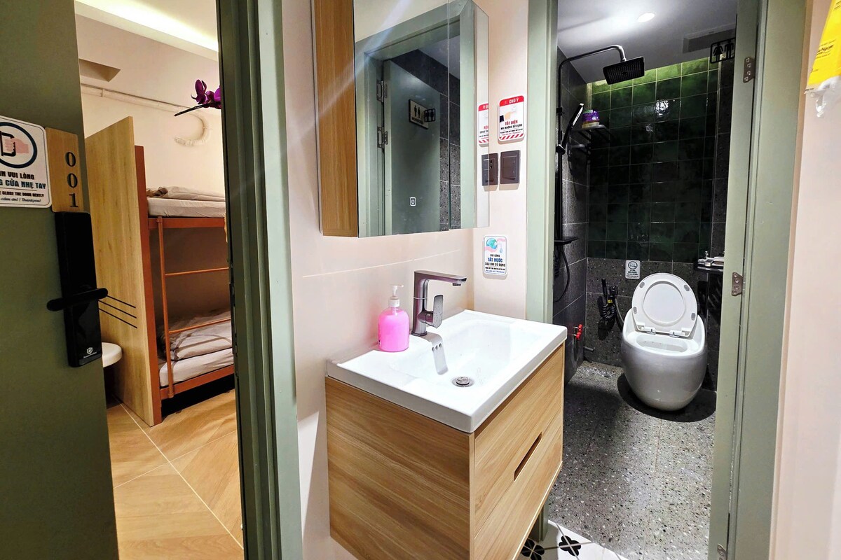 A modern bathroom with a sink, mirror, and shower.