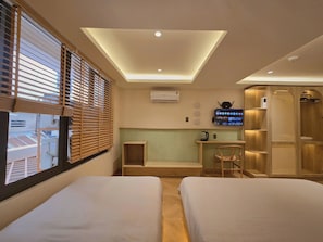 A hotel room with two beds, a desk, a TV, and a shower area. - Phuc Loc Premier (Ben Thanh)