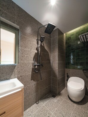A modern bathroom with a shower, toilet, and sink. - Phuc Loc Premier (Ben Thanh)