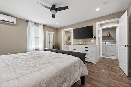 A bedroom with a bed, a ceiling fan, a TV, a wardrobe, and a bathroom with a shower.. Fish Camp Retreat Bay Access + Boat Parking
