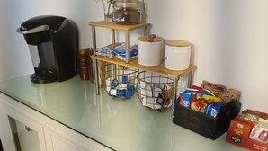 A kitchen counter with a coffee maker, jars, and packaged goods. - Charming Upper Flat 10 mins from Downtown Det-10 mins from Nautical Mile (Detroit)