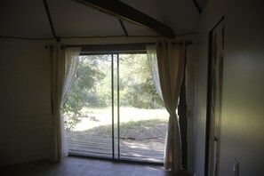 A room with a large sliding glass door leading to an outdoor area.