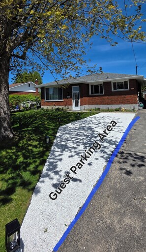 A guest parking area with a sign indicating its purpose. - Stylish, Spacious Home close to Trails & Amenities (Greater Sudbury)