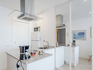 A modern kitchen with a microwave, refrigerator, and coffee maker. - Horizonte by Interhome (Calpe/Calp)