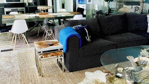 A living room with a sectional sofa, a coffee table, a dining table, and chairs. There is a water dispenser on the wall, a hanging plant, and a decorative wall piece. - Fish, Kayak, Unplug at a Private Waterfront Escape in Union. Visit Ark Encounter (Union)