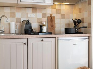 A kitchen with a dishwasher, a coffee maker, a cutting board, and a pot on the counter. - Stunning 4-person Sea View Haven (Roquebrune-sur-Argens)