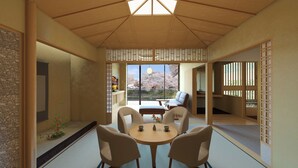 A traditional Japanese room with tatami flooring, a low table with cushions, and a view of cherry blossoms. - Honjin Hiranoya Omeiso (Takayama)