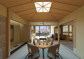 A traditional Japanese room with tatami flooring, a low table with cushions, and a view of cherry blossoms. - Honjin Hiranoya Omeiso (Takayama)