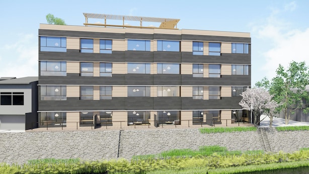 A multi-story building with a stone facade, large windows, and a rooftop garden. - Honjin Hiranoya Omeiso (Takayama)