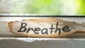 A wooden sign with the word 'Breathe.'
