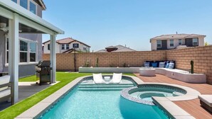 A swimming pool with a hot tub, lounge chairs, and a barbecue area. - Desert Oasis • Heated Pool & Spa • Sleeps 8 (Indio)