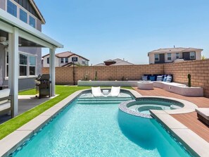 A swimming pool with a hot tub, lounge chairs, and a barbecue area. - Desert Oasis • Heated Pool & Spa • Sleeps 8 (Indio)