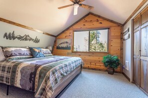 A bedroom with a bed, a ceiling fan, a window, and a plant. - Adorable High Mountain Retreat with HOTTUB! (Duck Creek Village)