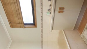 A bathroom with a bathtub, a shower, and a window. - All seasons for families
House on the hill 
NOW WITH  nbn, wi-fi and FOXTEL (Rosebud)