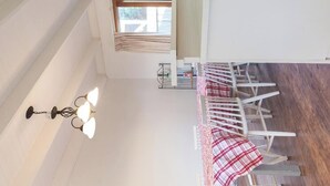 A kitchen with a window, a clock, and a dining area with chairs. - All seasons for families
House on the hill 
NOW WITH  nbn, wi-fi and FOXTEL (Rosebud)