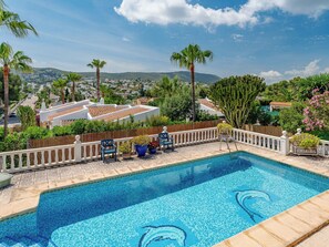 A swimming pool with a tiled deck, surrounded by a white fence and potted plants. - El Refugio de Rembrandt by Interhome (Jávea)