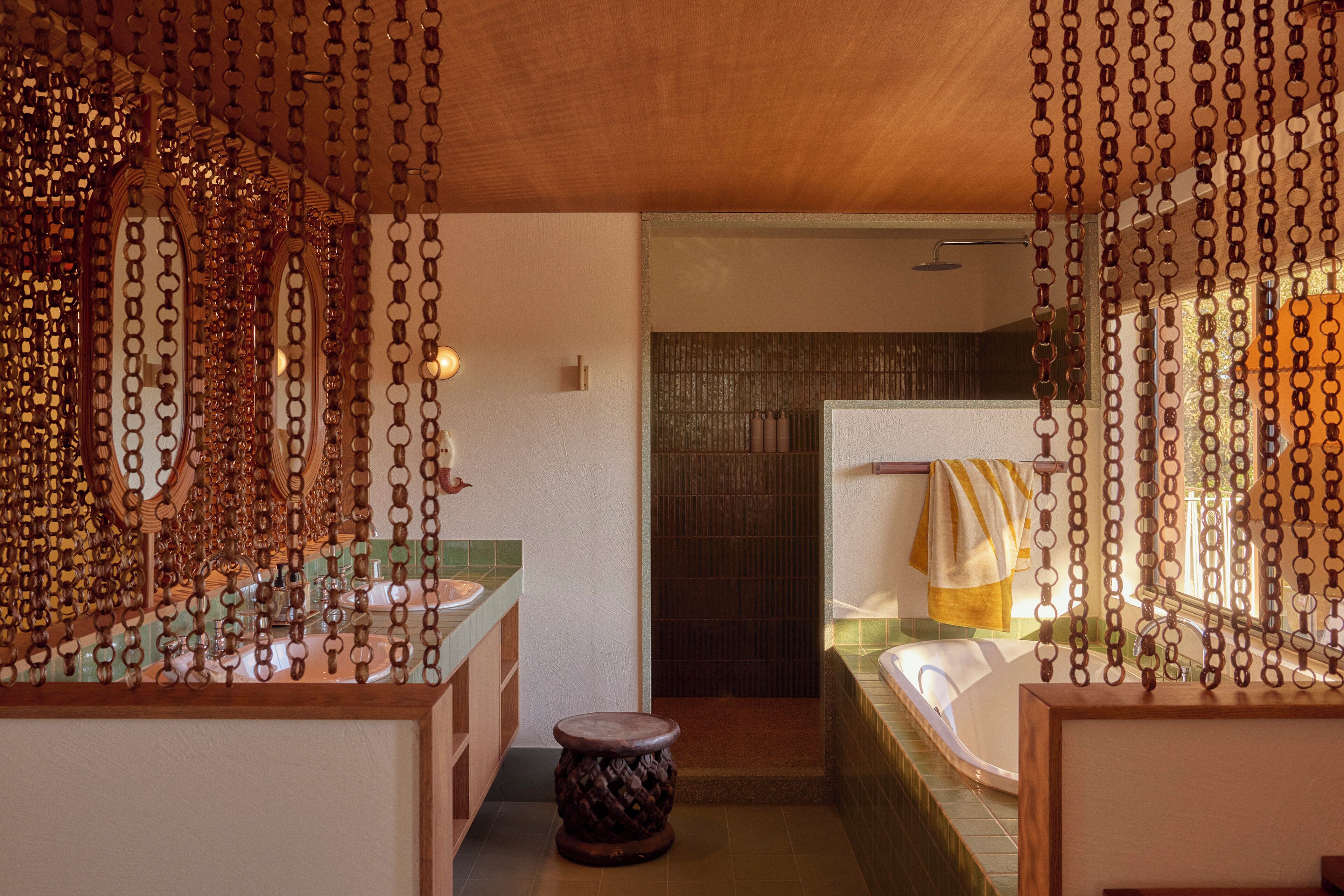 A bathroom with a wooden vanity, a bathtub, and a shower area.