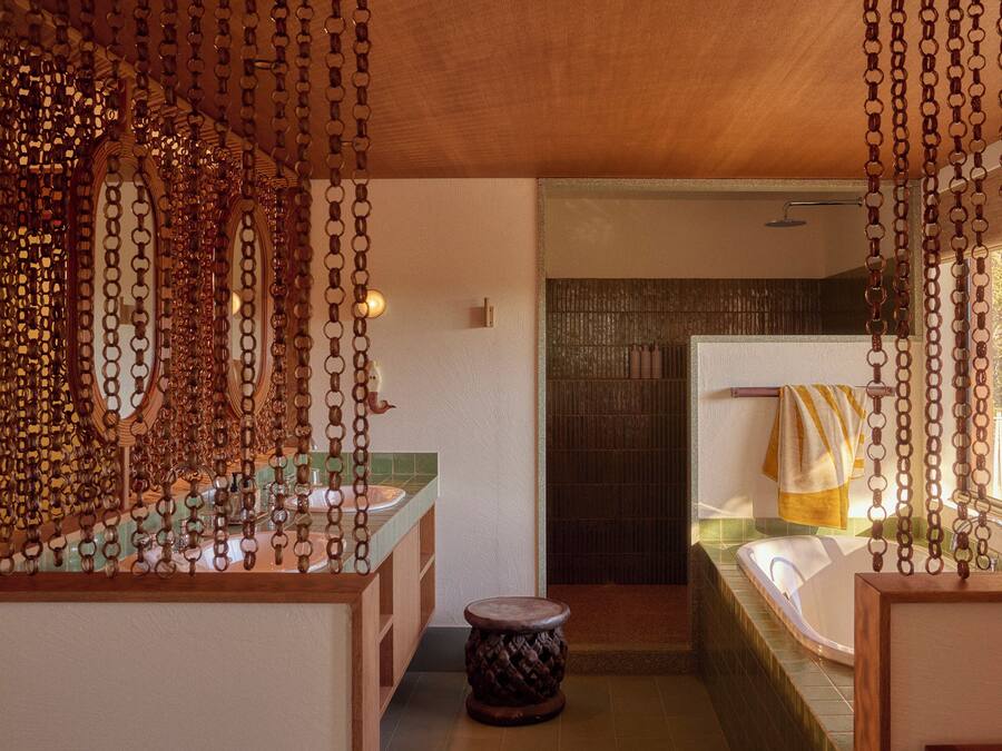 A bathroom with a wooden vanity, a bathtub, and a shower area.