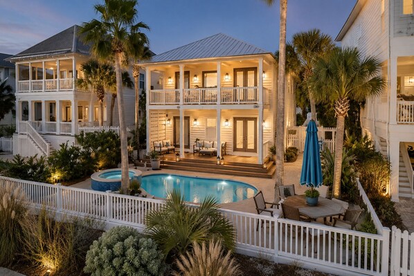 A two-story house with a pool, a covered patio, and a white picket fence. - Waverly Oasis at Destin Pointe | Private Pool, Resort Amenities & Beach Access (Destin)