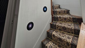 A staircase with patterned carpet, a woven light fixture, and a small skylight. - House for 1–8 people, garden, 10 minutes from Futuroscope and downtown, French “ 1965-1970 ” decor (Poitiers)