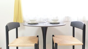 A dining table with two chairs, a glass, and plates. - Fontaine Kamata by Tranova 2 (Ota City)