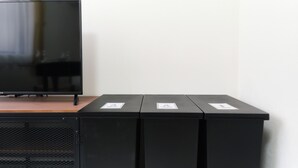 A television on a wooden surface with three black cabinets below it. - Fontaine Kamata by Tranova 2 (Ota City)