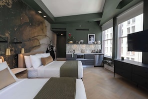 A modern hotel room with two beds, a kitchenette, a large window, and a TV. - Two Bedroom Suite Near Flatiron & Broadway (New York)