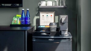 En kaffestation med menu, kaffemaskine og drikkemaskiner.